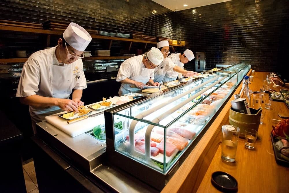 Chefs preparing sushi behind the counter at Blue Ribbon Sushi Bar & Grill