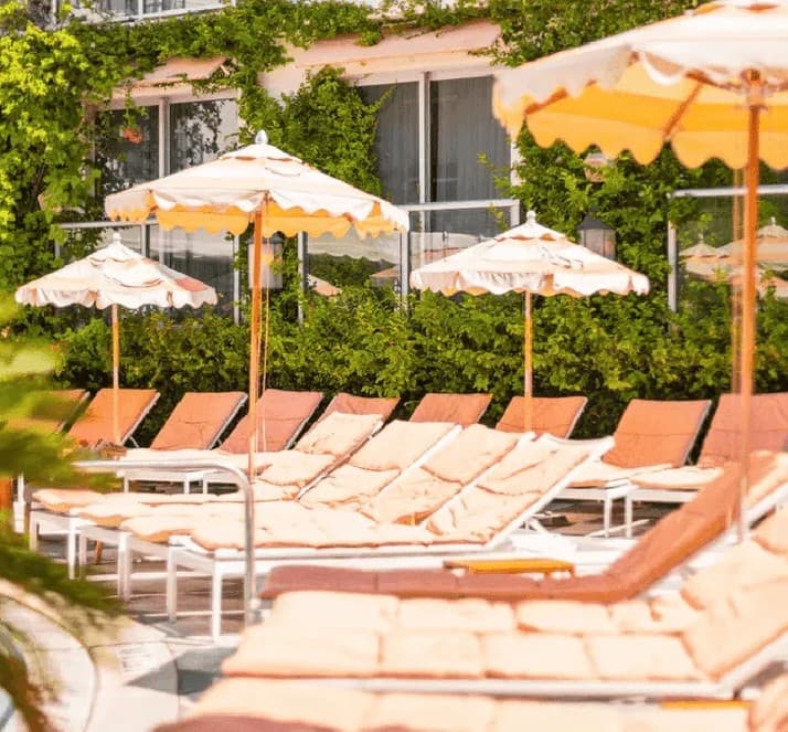 Loungers and fringed umbrellas on the pool deck at The Plymouth